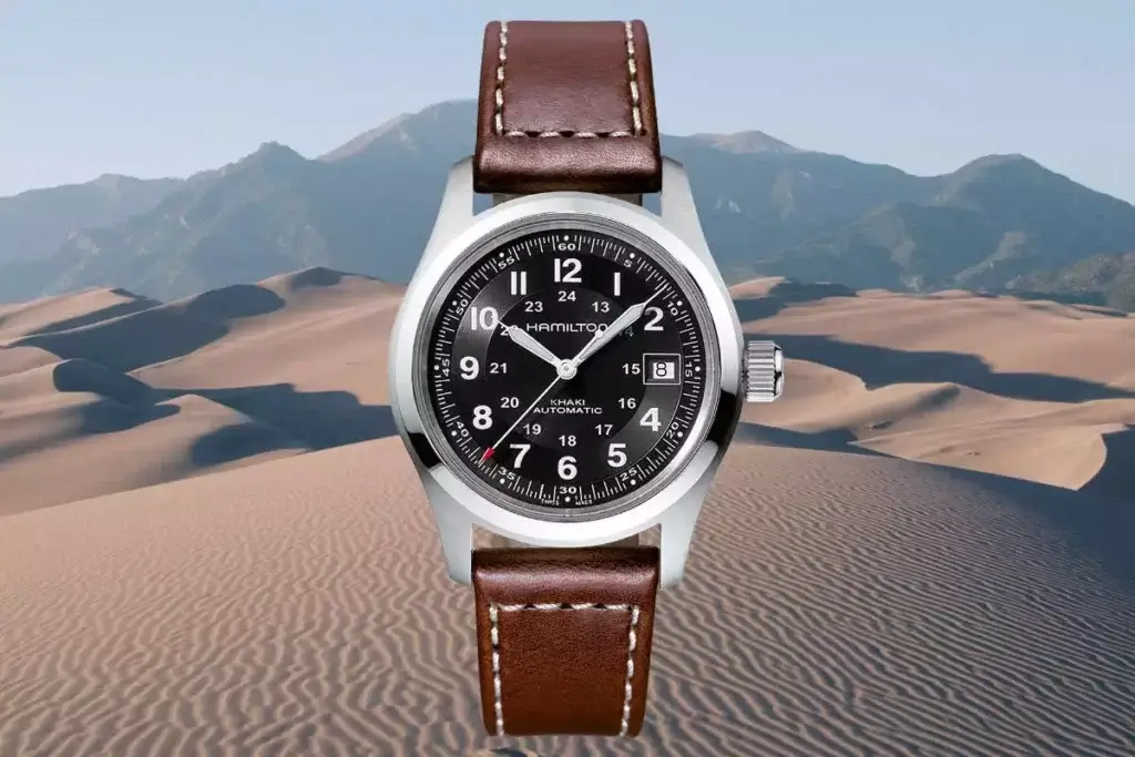 Hamilton Khaki Field Automatic watch with a black dial and brown leather strap pictured in the dessert