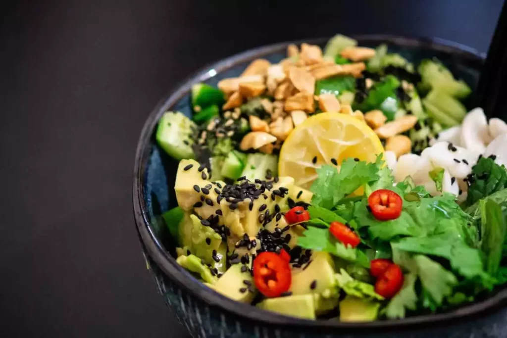 Bowl with fresh food such as lemons, cucumber, parsley and more as part of a Keto diet. 