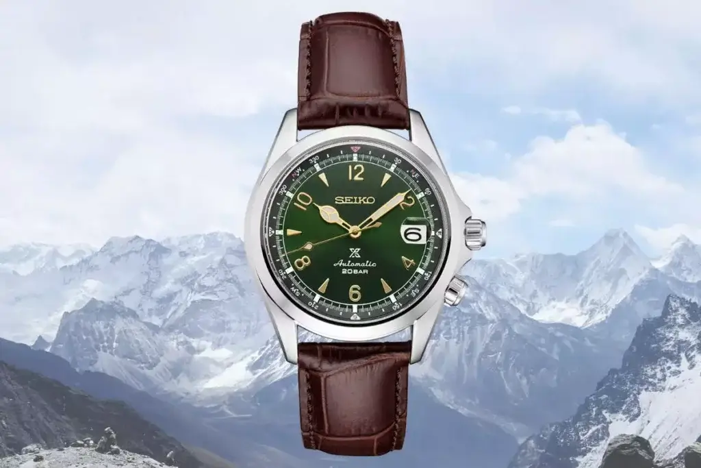 Seiko Prospex Alpinist wristwatch with green dial on the brown leather strap captured in the mountains