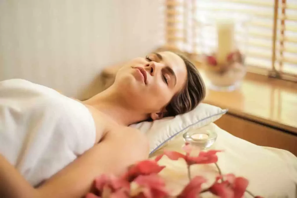 A relaxed young woman receiving a spa treatment and massage.