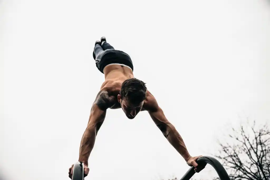 A photograph of a young man practicing artistic gymnastics, which is one of the best Olympic sports for short guys.