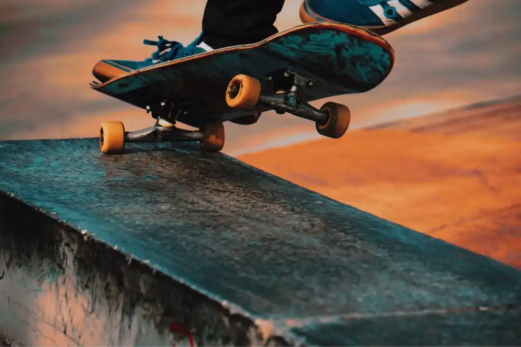 Image showing a skateboard and skateboarder's shoes in action, as skateboarding is one of the best sports for short people.  