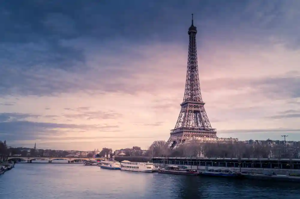 A romantic, sunset photograph of Eiffel Tower in Paris, France, also known as the city of love.